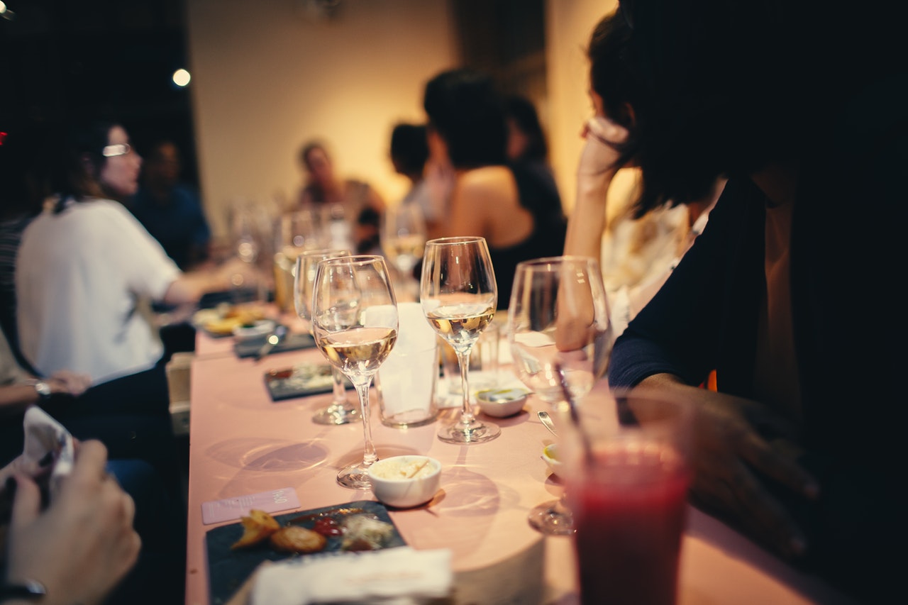 People at a long table with wine glasses